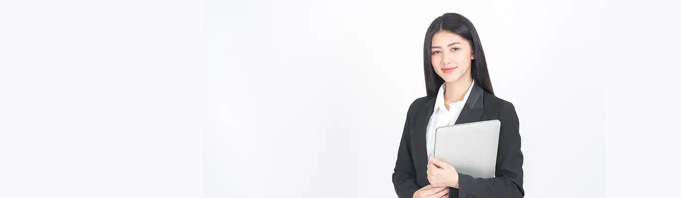 An ethical hacking student standing with a laptop in hand