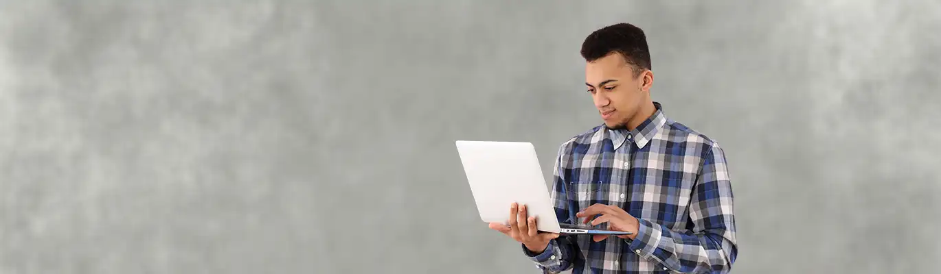 Picture of a network security student in front of a laptop