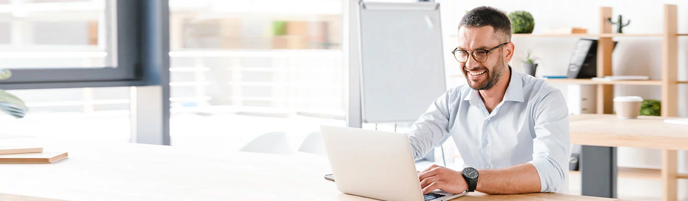 A Microsoft professional working on a drawing room with his laptop on table